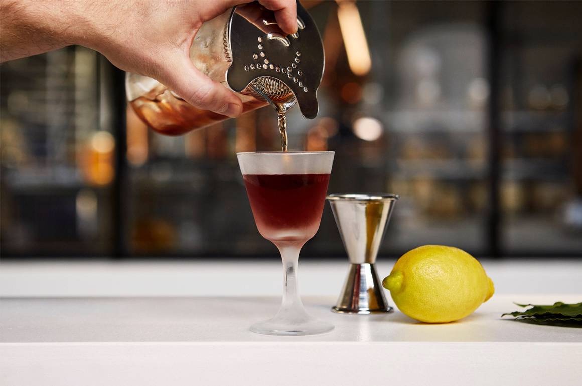 cocktail på bar bliver hældt op